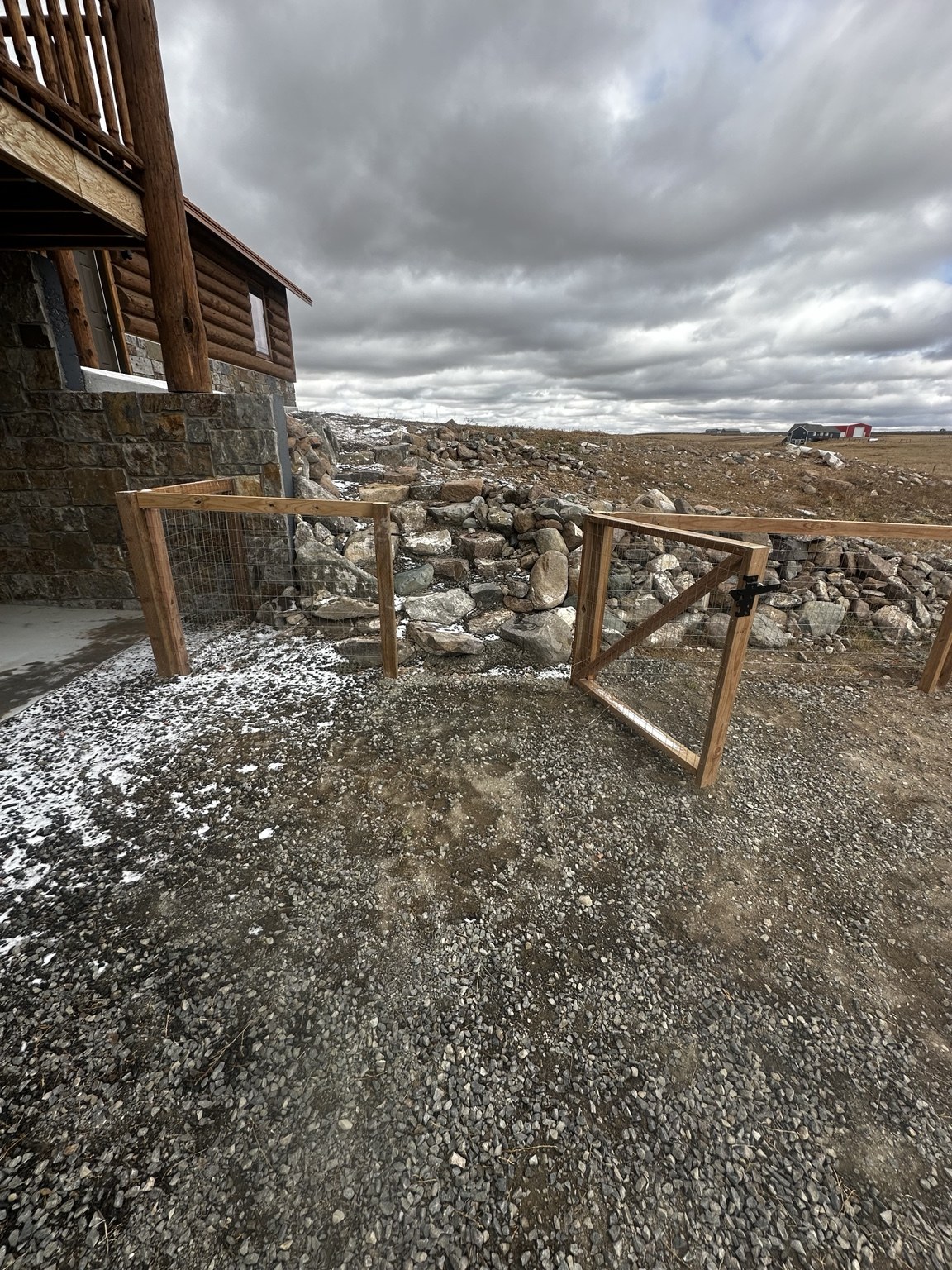 Wire mesh fence enclosure beside a rural home