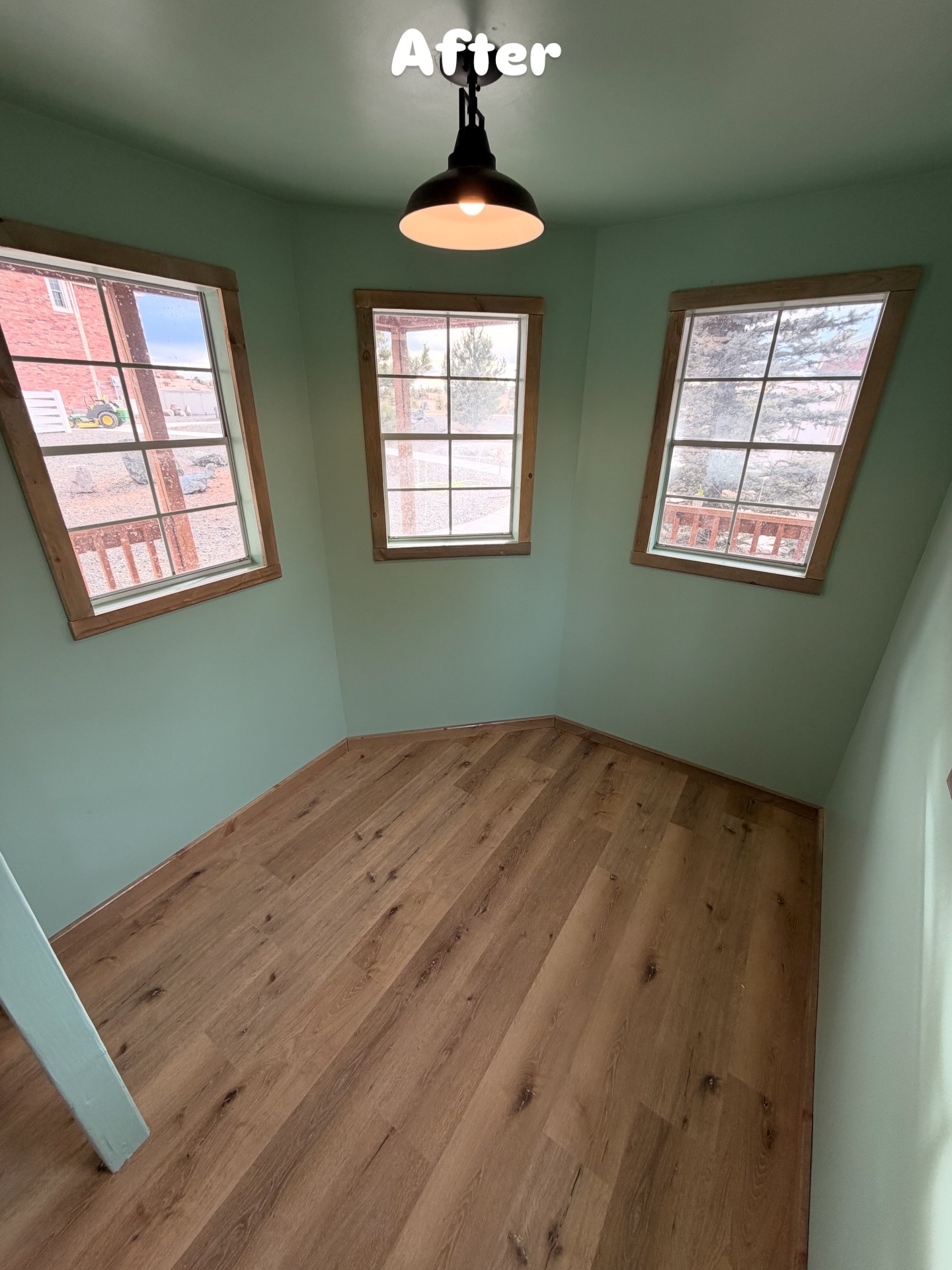 Finished shed interior with plank flooring and painted walls